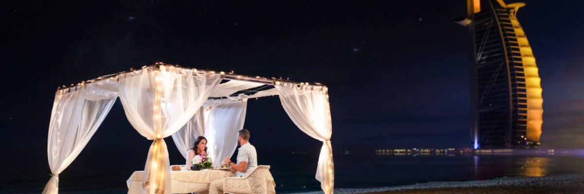 couple having dinner on beach burj al arab